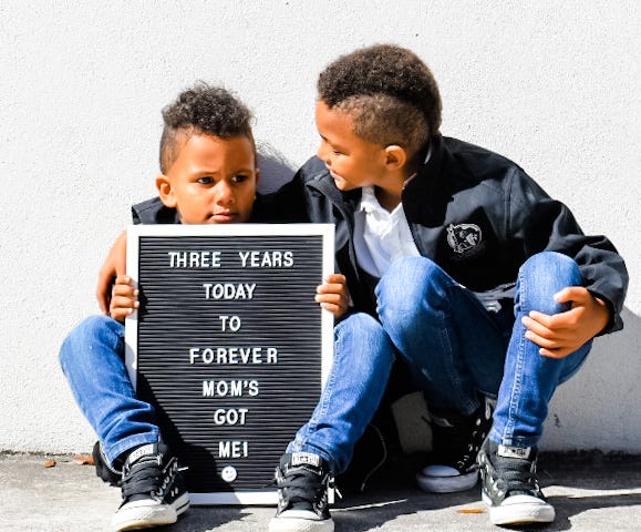 Two boys posing on one boy’s adoption anniversary