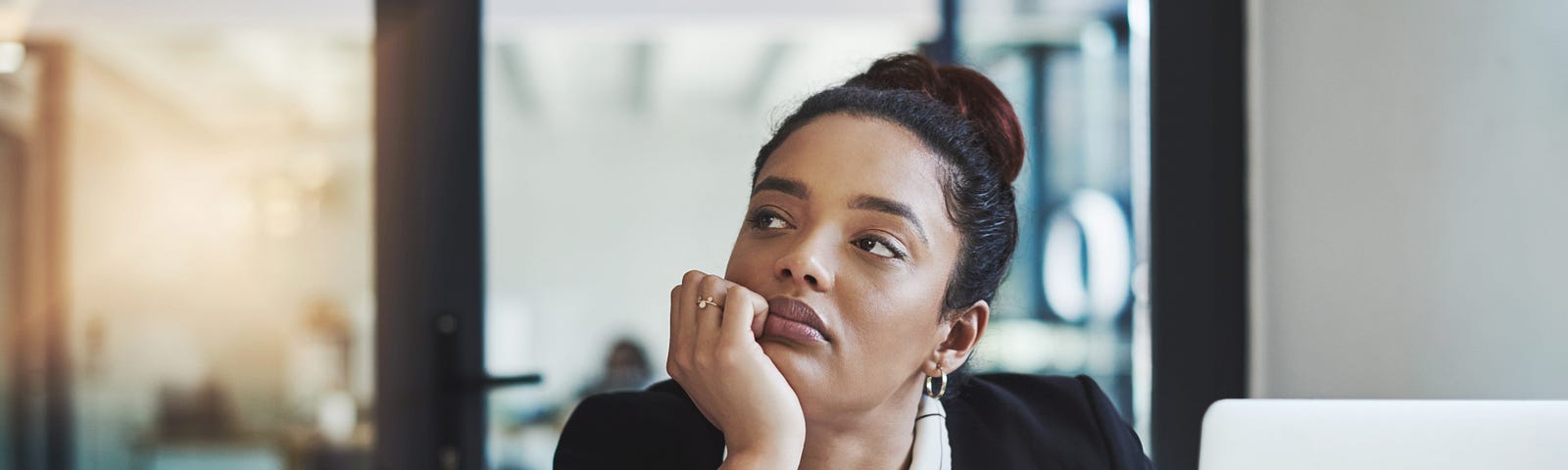 A young businesswoman looking bored while working at her desk in a modern office