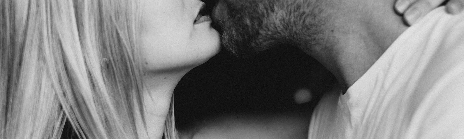 Woman and man kiss, photo taken in black and white
