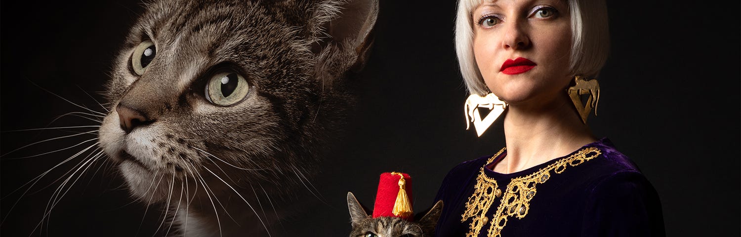 A retro yearbook style portrait with a cat’s head superimposed behind a blonde woman holding the cat, who’s wearing a red fez