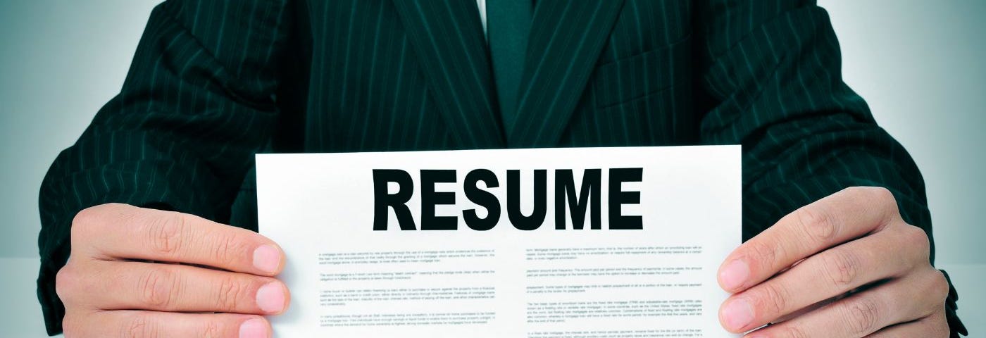 Image of person posing with a resume document