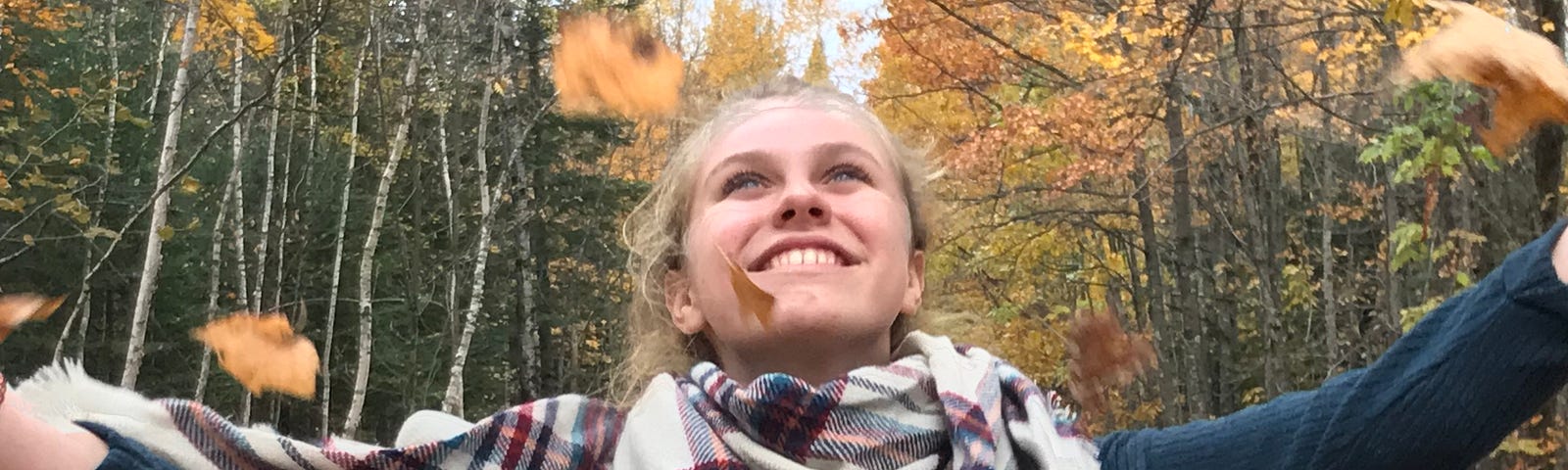 The author throwing leaves into the air