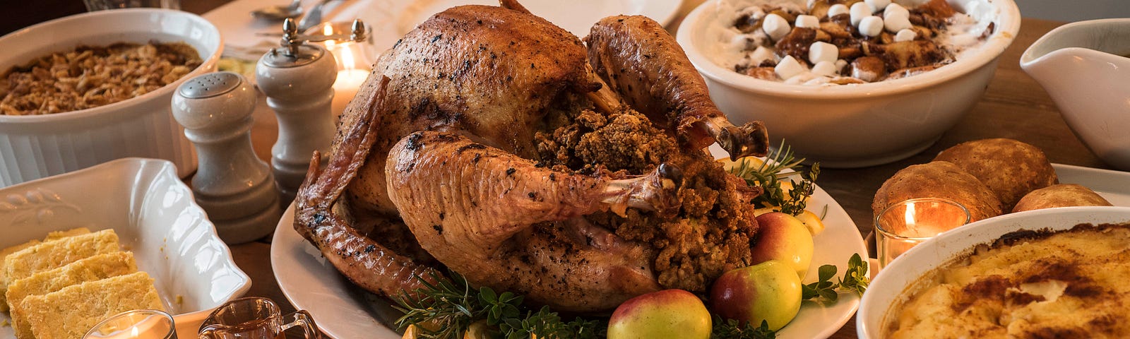 A dining table filled with Thanksgiving food.