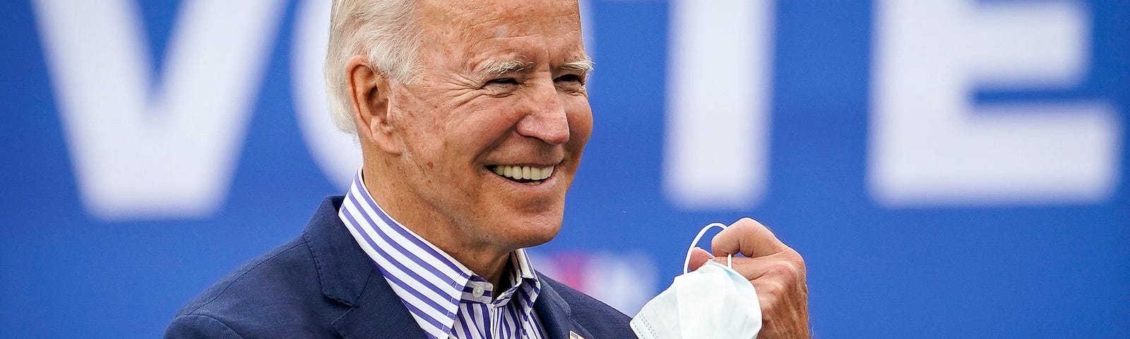 Joe Biden takes off his face mask to speak during a drive-in campaign rally in Pennsylvania.