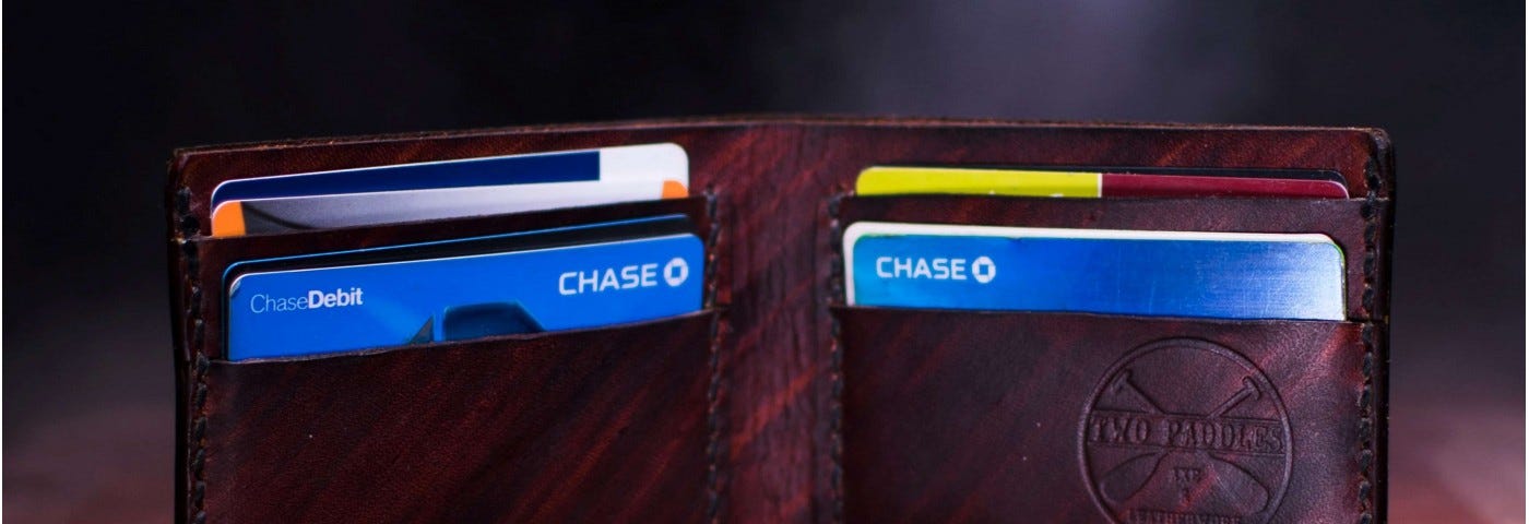 A bi-fold wallet open to show a bunch of credit cards.