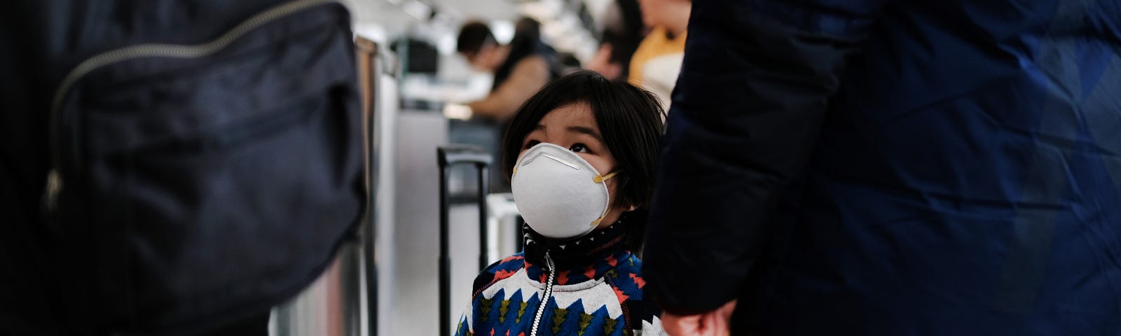 A child wears a medical mask out of concern over the Coronavirus at the JFK terminal that serves planes bound for China.