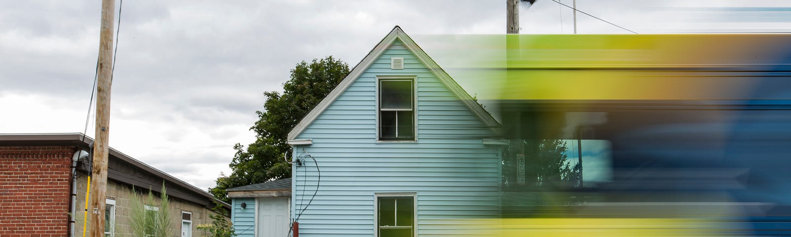 A luxury 5-story condominium building is proposed to replace this narrow two-story house at 180 Washington Ave.