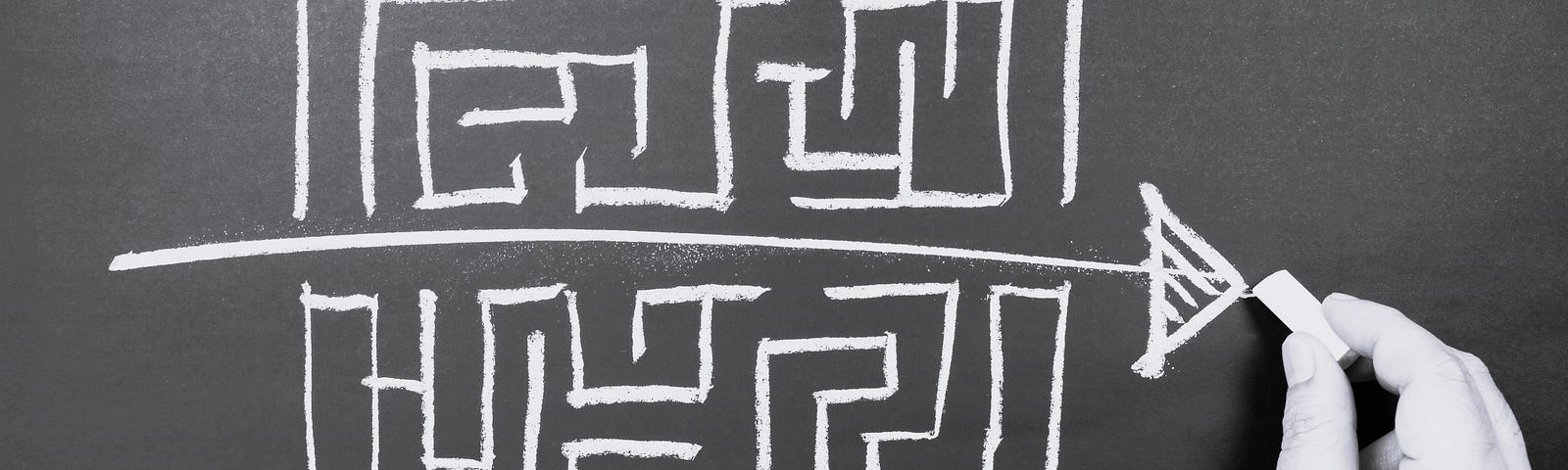 A drawing on a chalkboard of a maze with a single straight line and arrow drawn through the center, by-passing the twists and turns to exit quickly.