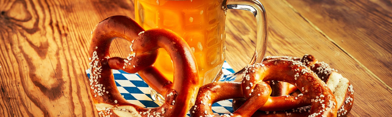 A giant frothy beer and soft pretzels