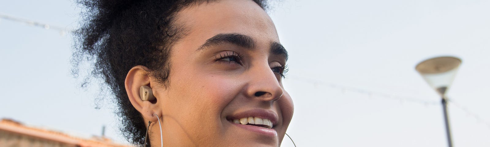 Confident young woman with hoop earrings.