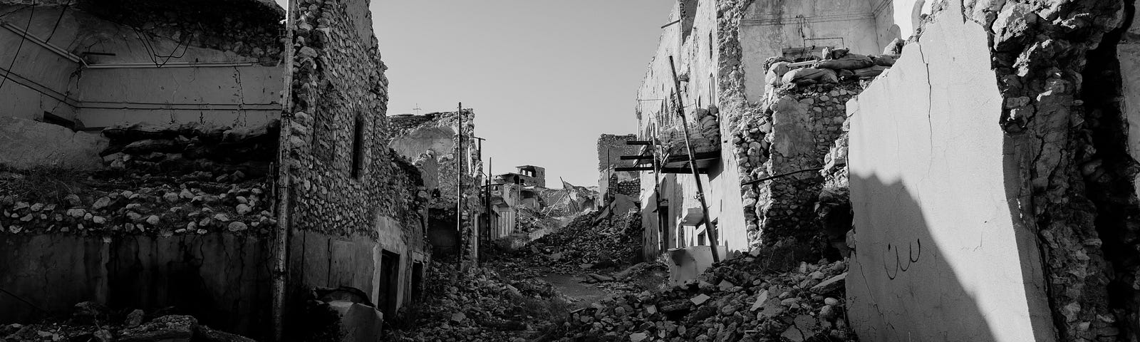 A black and white image of destroyed buildings and rubble