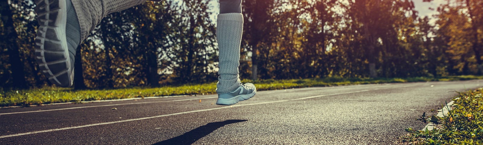 A shot of a person’s legs as they run down the street.