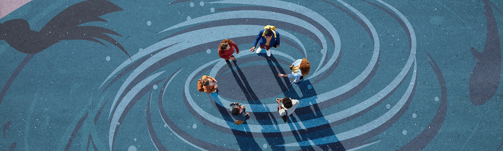 A group of young adults in a circle facing each other, photographed from above, on a painted tarmac surface showing a vortex.