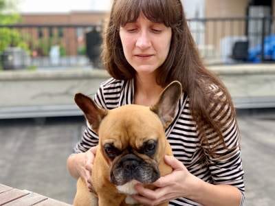 Sabrina, Principal Design Strategist at &Partners, holding a cute dog.