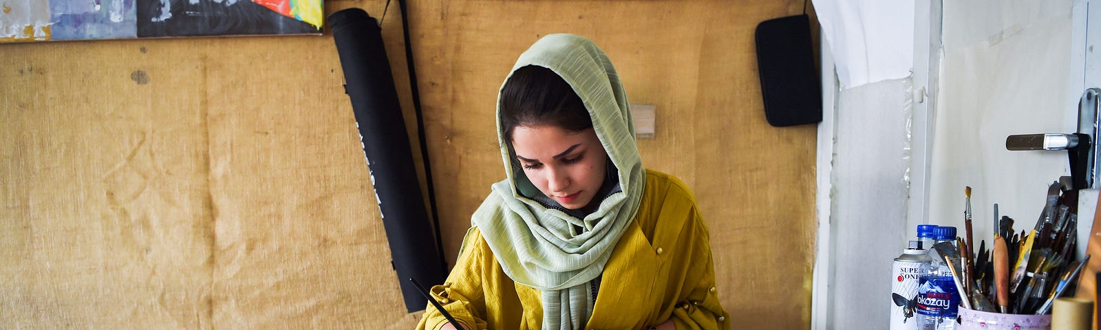 A 24-year-old artist and designer Zahra works in her office in Kabul.