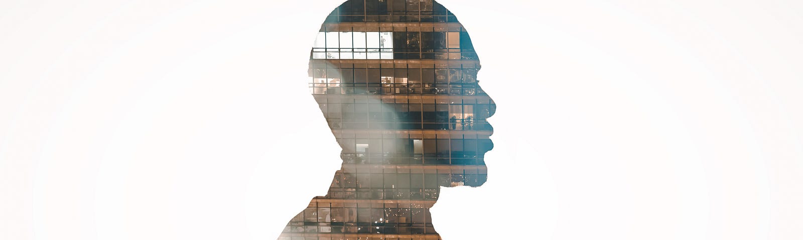 Profile view silhouette of businessman double exposed with city at night.