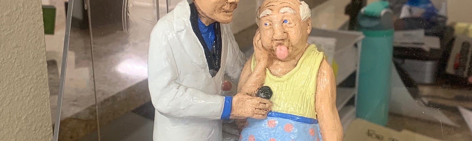 A photo of a plaster figurine of a cardiologist and patient