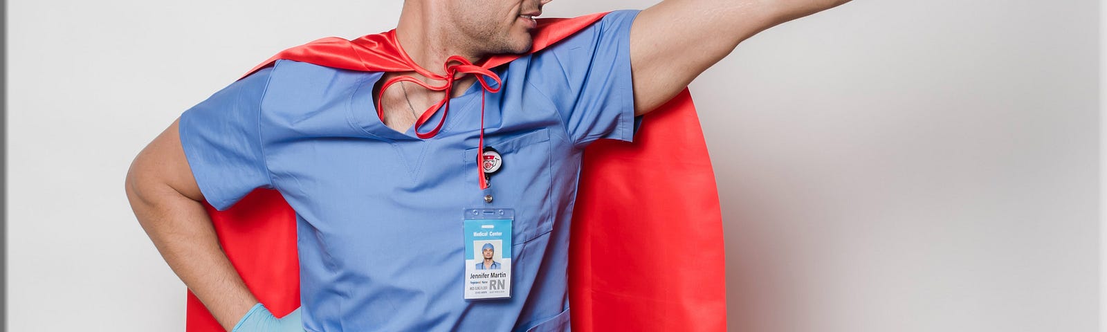 Male nurse dressed in superhero cape and mask