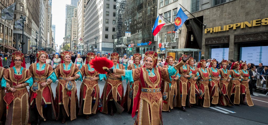 Dancers wearing Spanish costumes marching down 5th Avenue in New York for Hispanic Heritage Month.