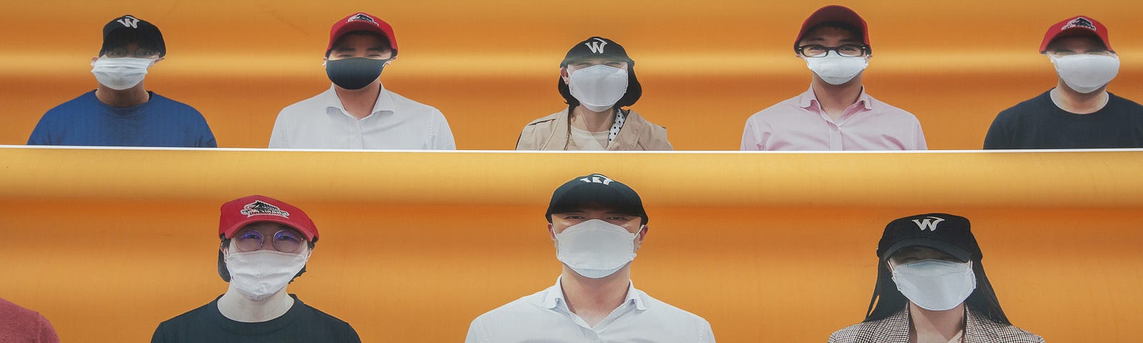 Banners showing faces of fans are placed in the seating area of Happy Dream Ballpark during a baseball game in South Korea.