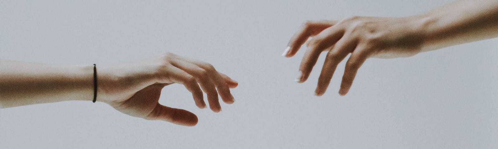 Hand reaching out to another hand