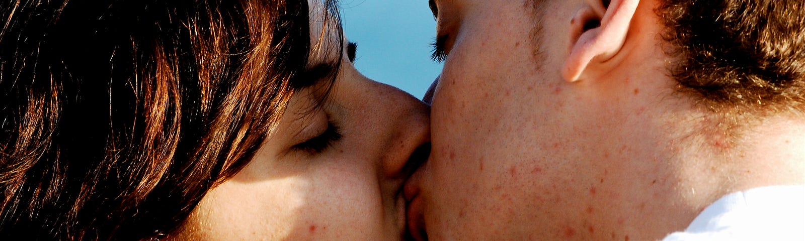 A young couple kissing.