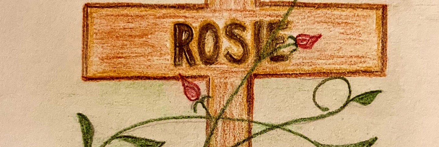 A hand-drawn illustration of a brown cross entwined with rose buds and the name ‘Rosie’ on it.