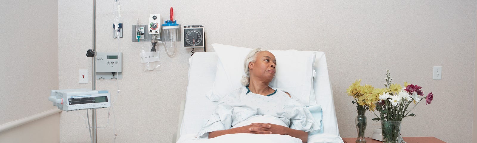 An elderly Black woman as a patient at the hospital.