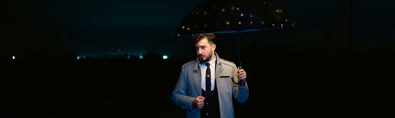 A smart-dressed man with an umbrella