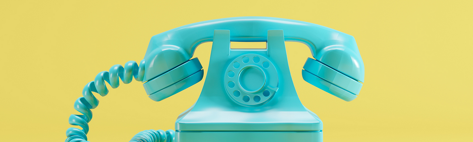 A photo of a teal old-fashioned phone against a yellow background.