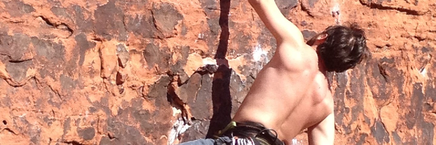 Man rock climbing with very little gear