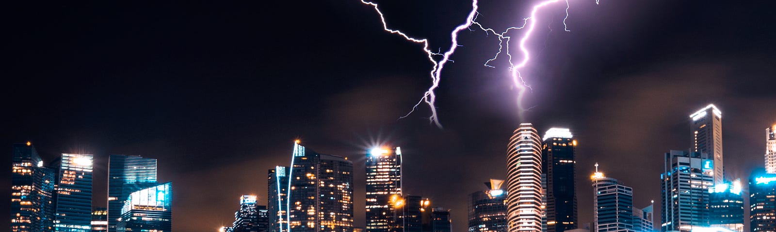 Purple lightning striking a city skyline