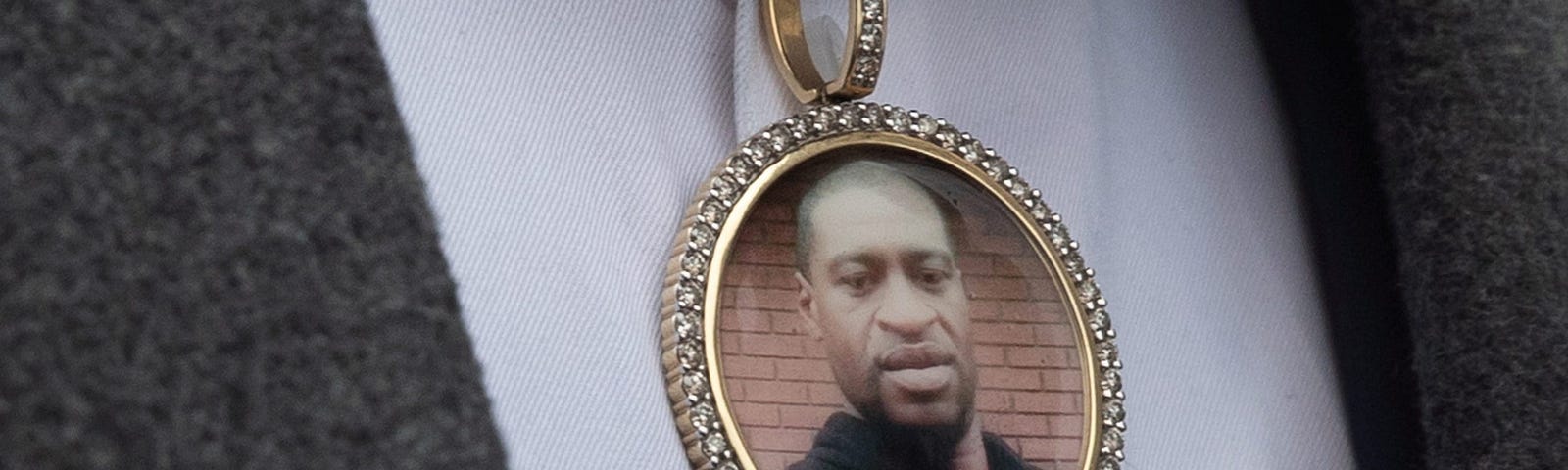 An image of George Floyd in a necklace worn by a family member.