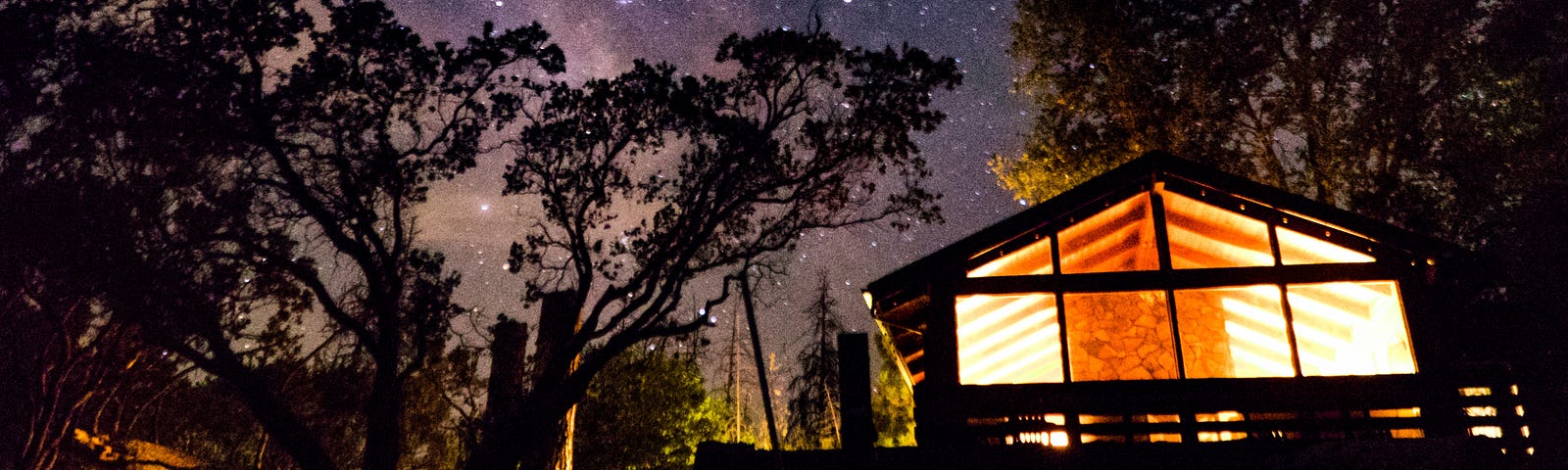 A cabin, very starry sky above