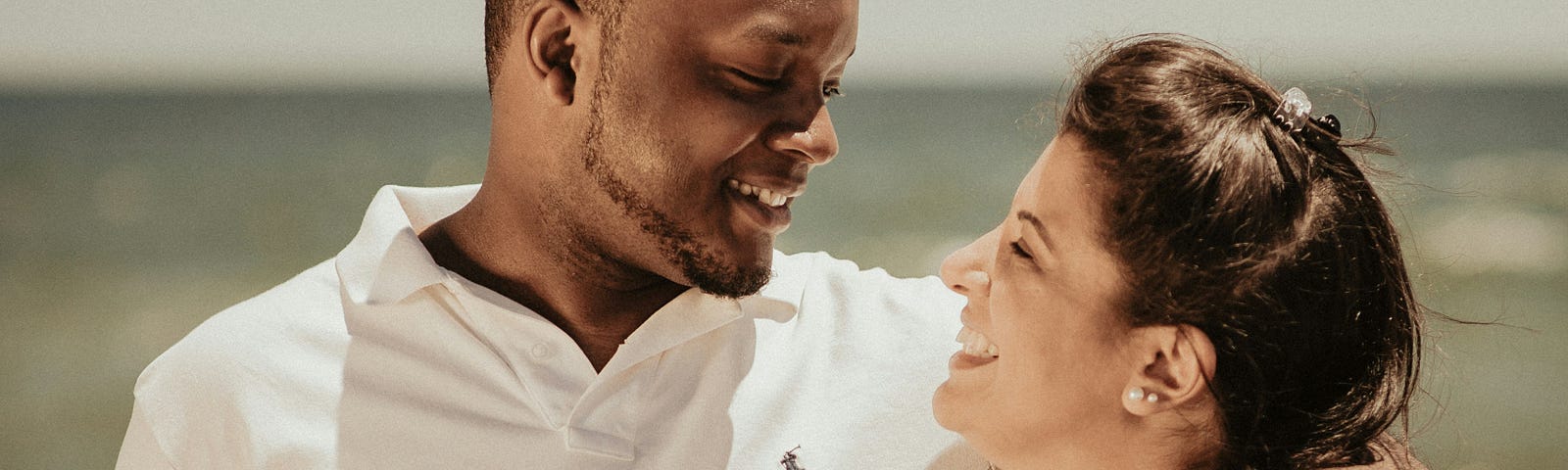 A young couple in love walking on the beach