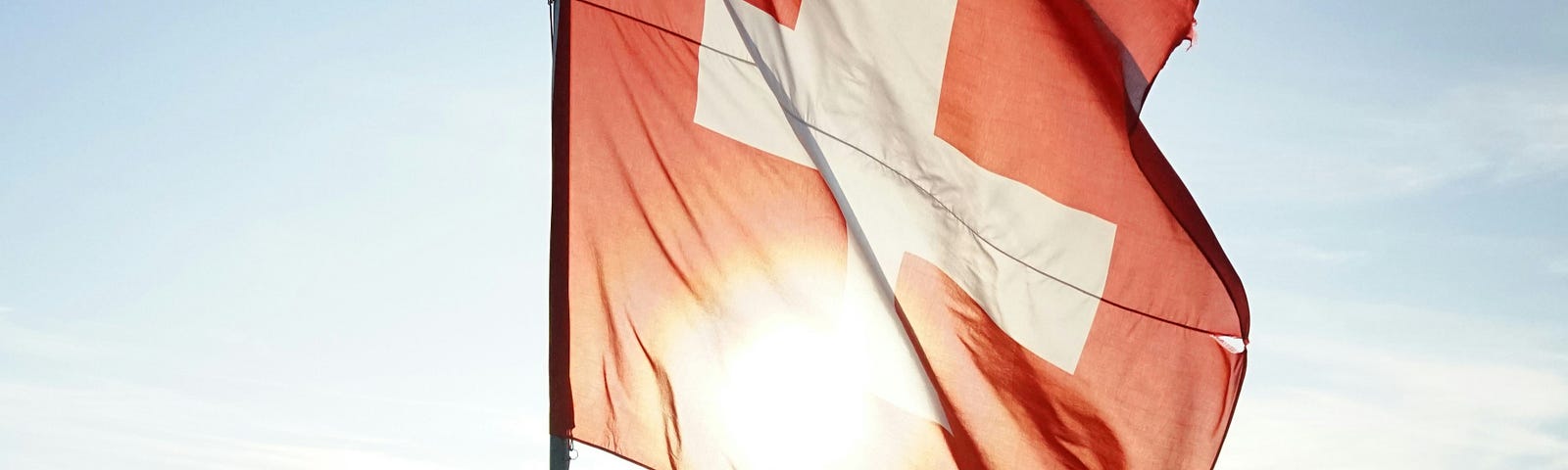 Switzerland flag at the top of a mountain