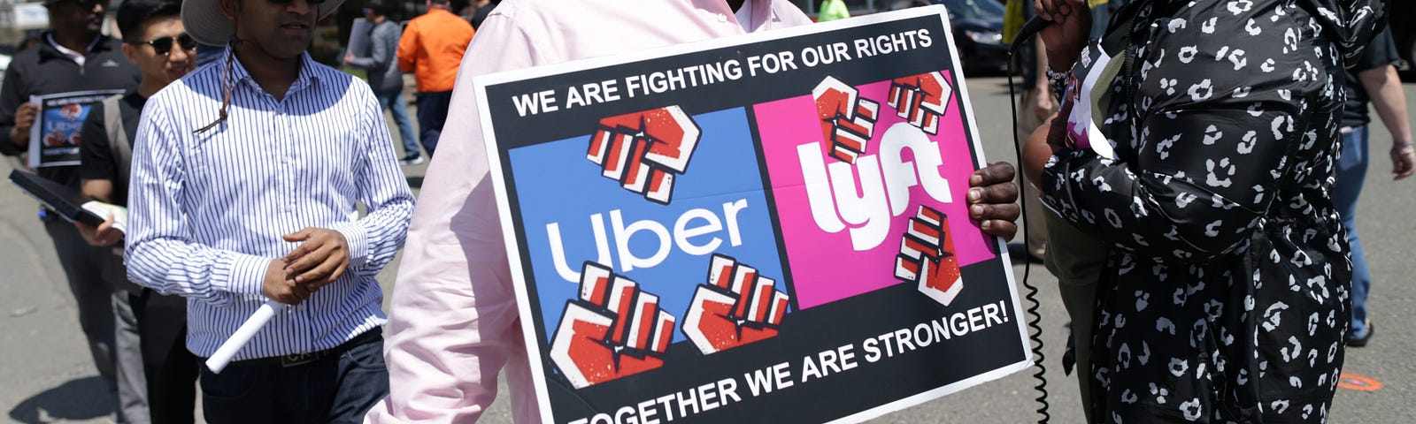 Uber and Lyft drivers protest outside the Uber offices in Saugus, MA.