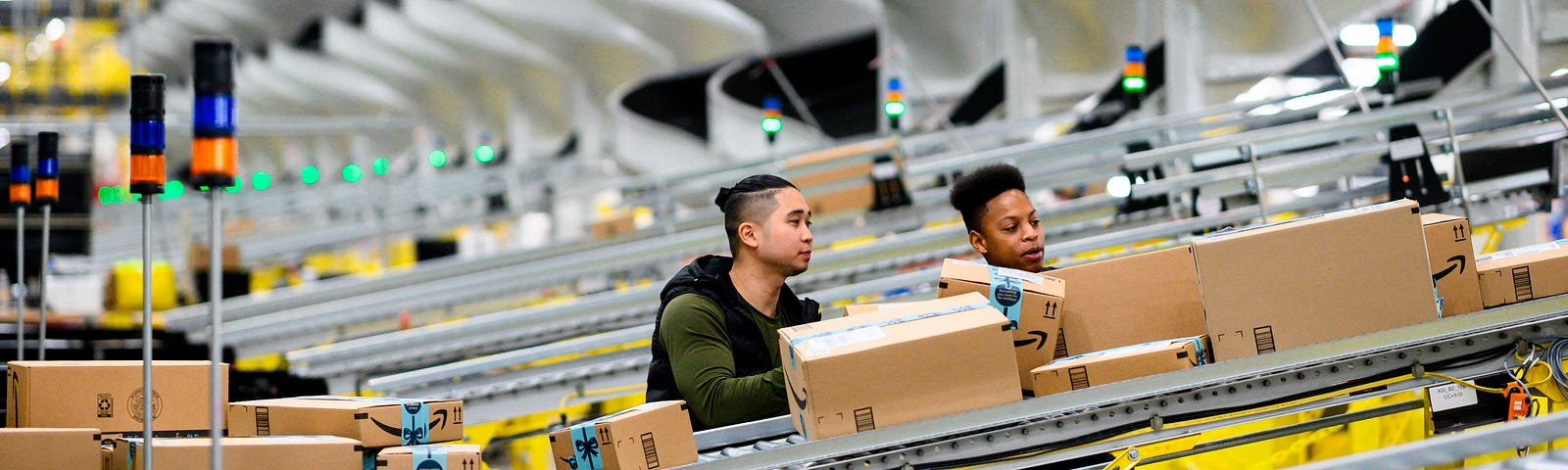 Men work at a distribution station in the 855,000-square-foot Amazon fulfillment center.