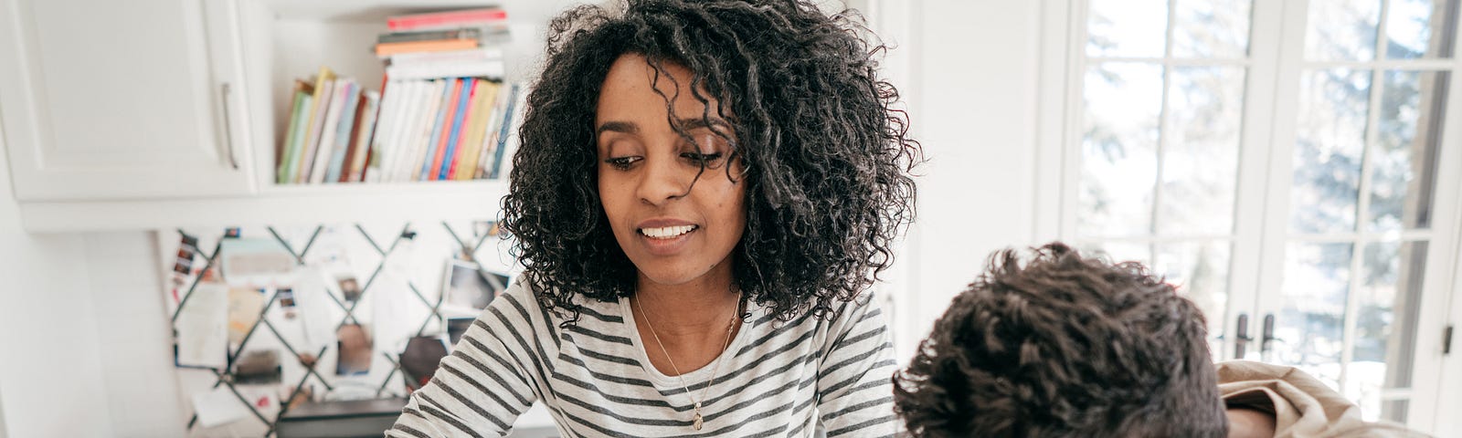 A mother helping her son study and read.