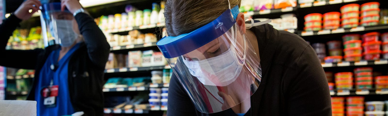 A healthcare worker takes a sample from a woman at a New York State Department of Health Covid-19 antibody testing center.