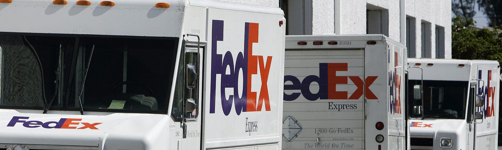 FedEx trucks lined up on a street