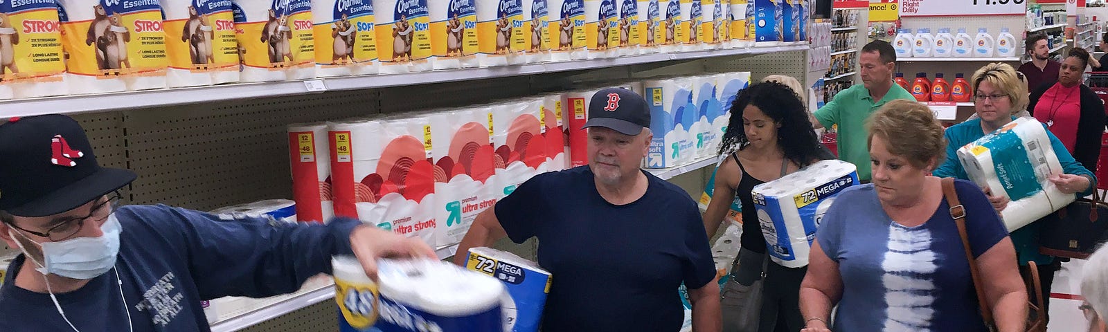 Customers rush to purchase toilet paper at a Target store during panic shopping.