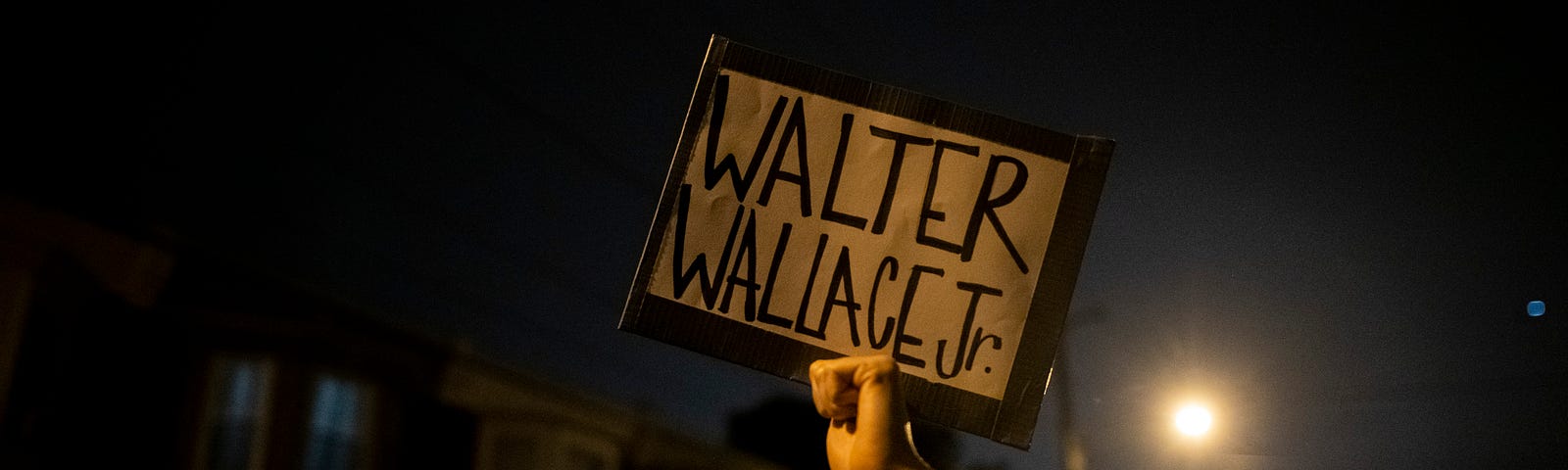 Protestors holding a placard reading “WALTER WALLACE JR.” near the location where Walter Wallace Jr. was killed.