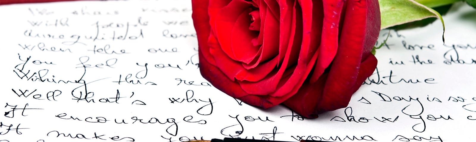 Love letter, red rose and fountain pen.