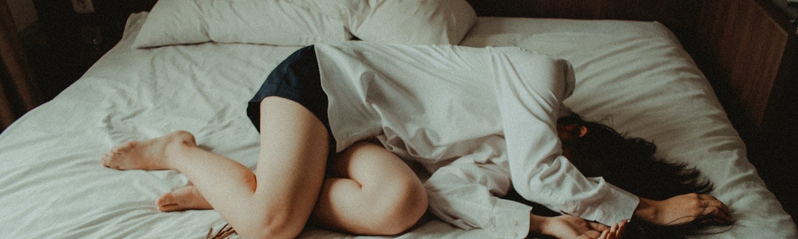 A girl lying in bed — looks dejected