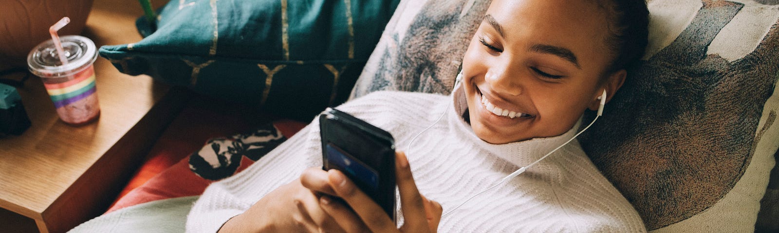 Young woman smiling while on the phone.