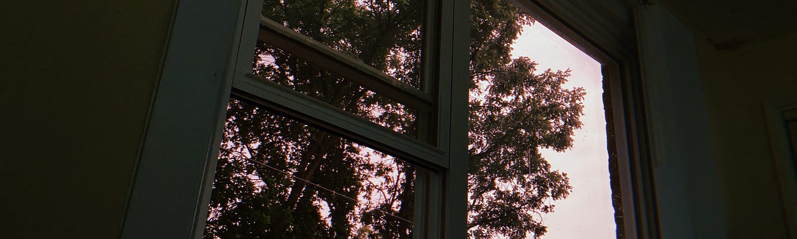 Photo dated to 7/15/2020 of a window with slightly light pink sky.