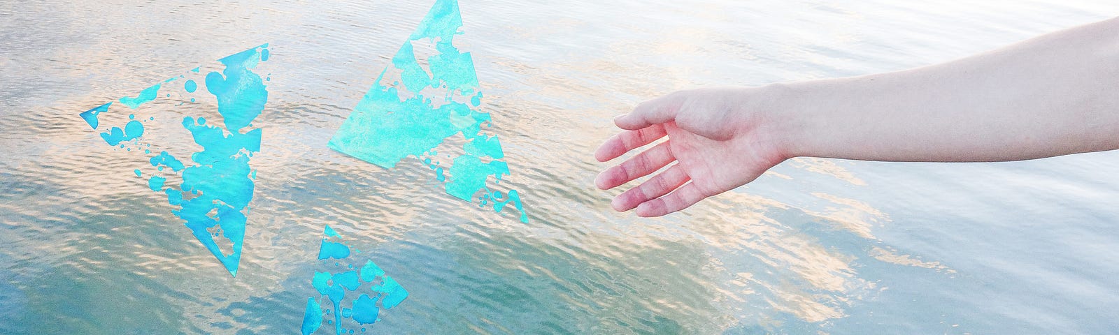 A photo of a hand extending to water with three abstract triangles.