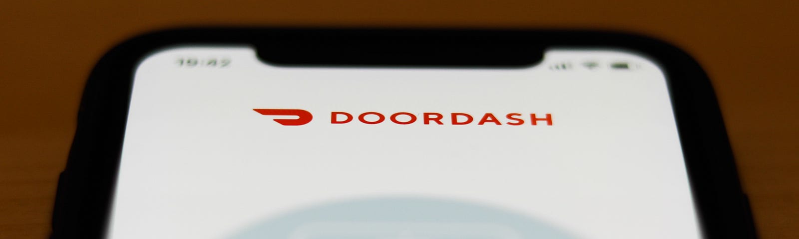 The Doordash app logo is seen on an iPhone screen.