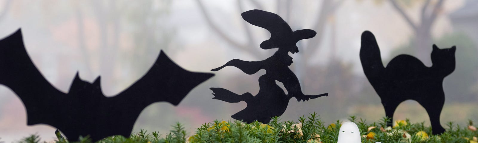 Halloween garden ornaments on a foggy morning, white ghost, black bat, witch and cat | nature photography | © pockett dessert